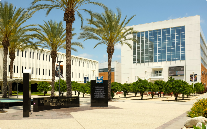 Cal State Fullerton sign with Mihaylo Hall on the campus of California State University Fullerton