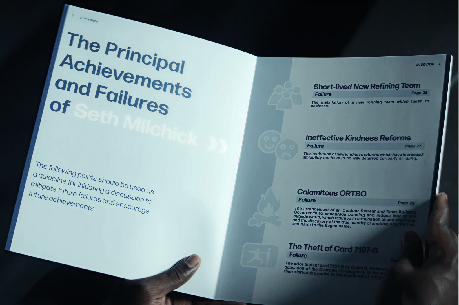 A still from Apple TV’s show “Severance” showing a manager reading his performance report.